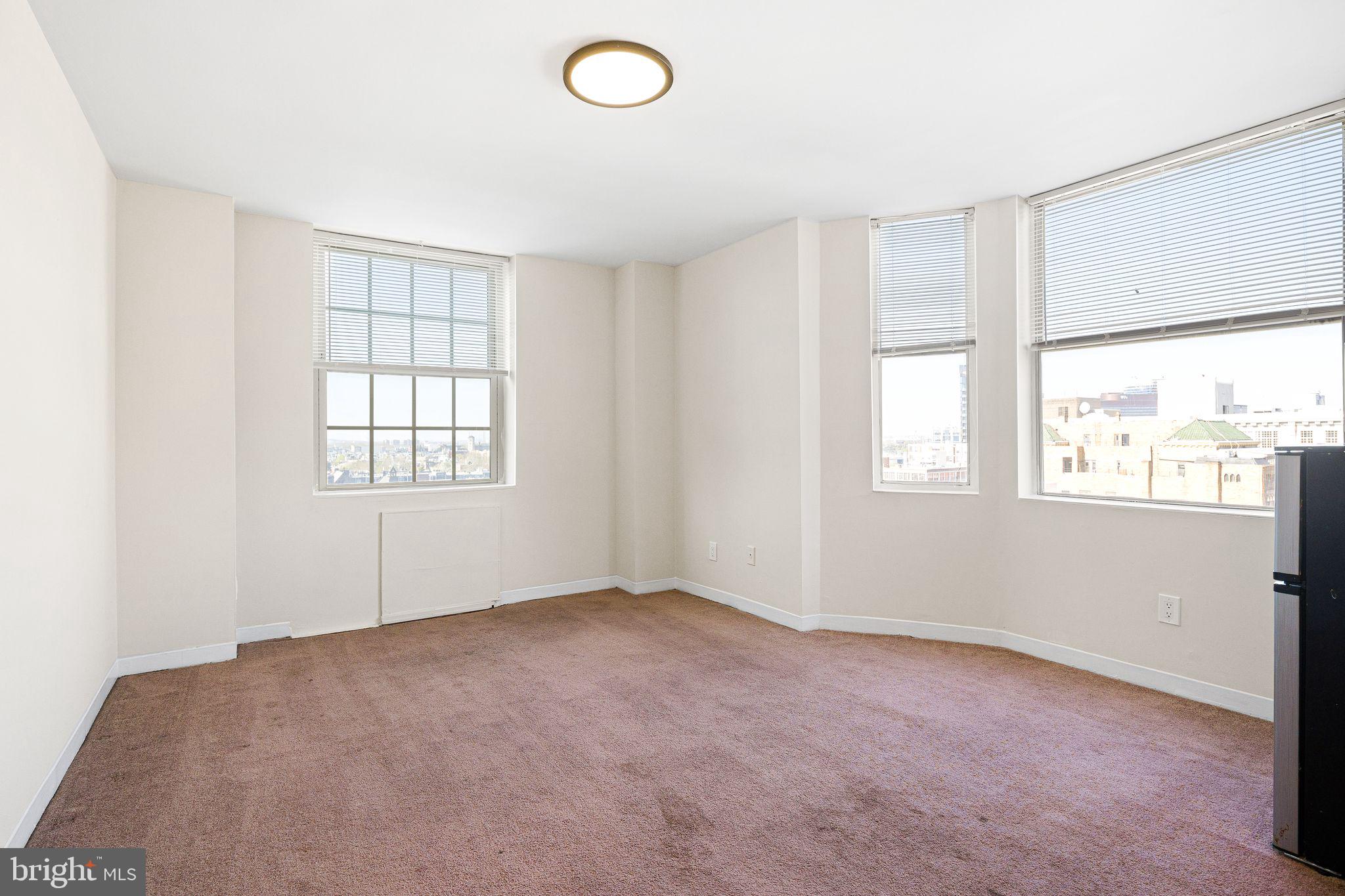 2135 Walnut Street, Unit 1103 Philadelphia, PA 19103 - Photo 5 of 18 an empty room with windows