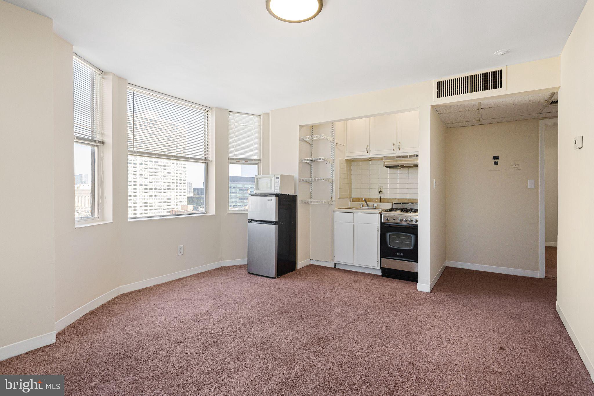 2135 Walnut Street, Unit 1103 Philadelphia, PA 19103 - Photo 9 of 18 a view of a kitchen with a sink and dishwasher windows
