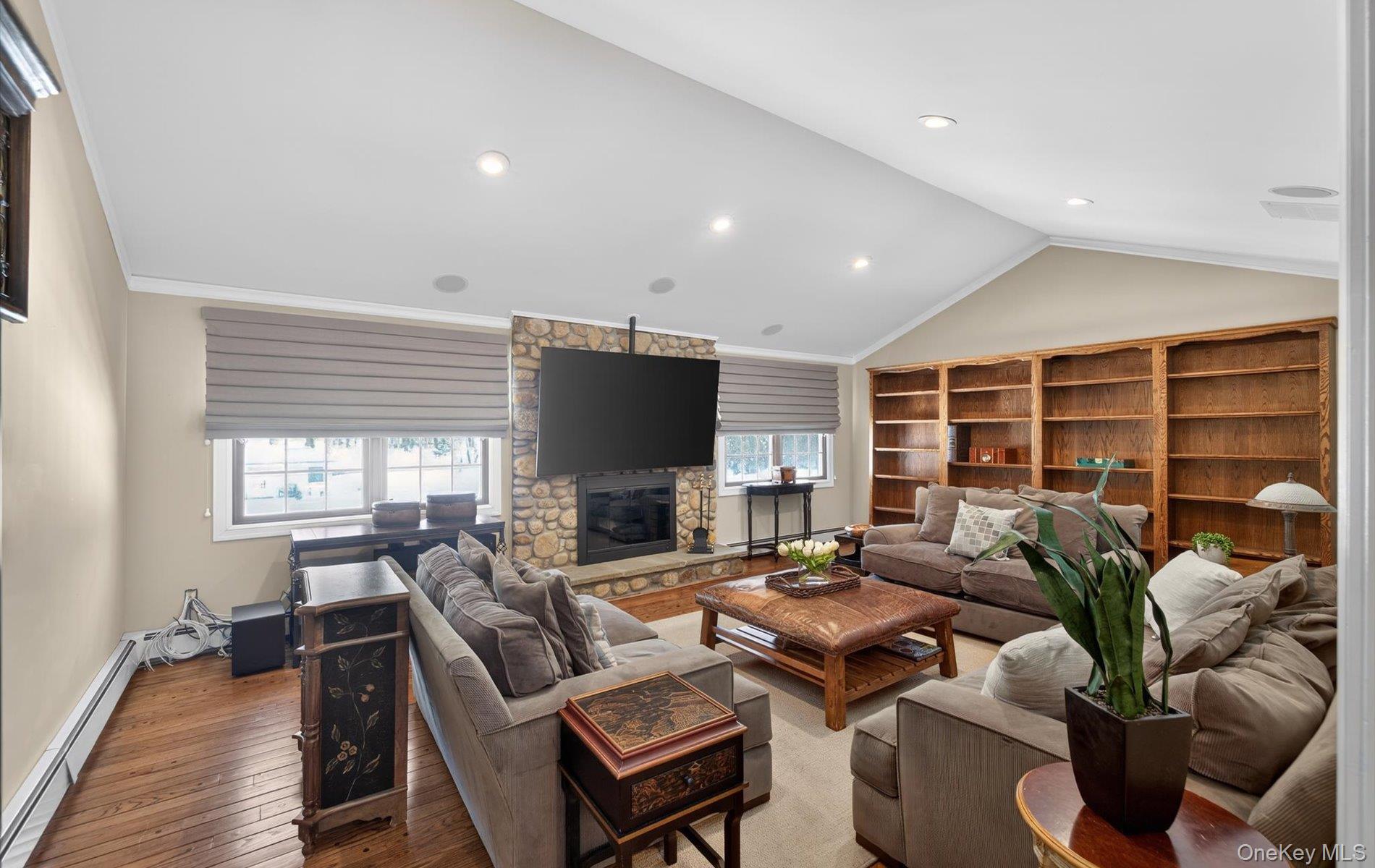 15 Tiber Road Syosset, NY 11791 - Photo 13 of 46 a living room with furniture a flat screen tv and a large window