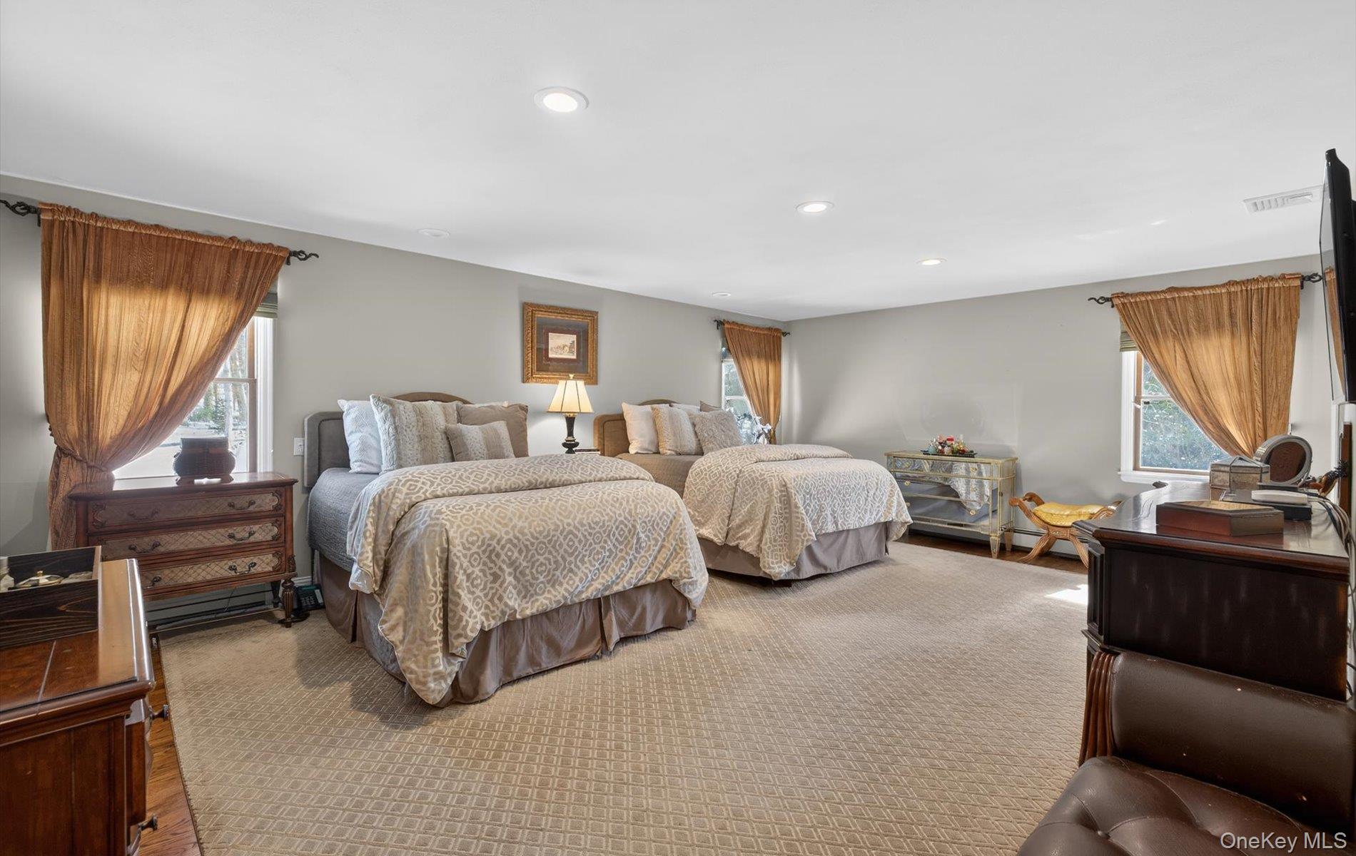 15 Tiber Road Syosset, NY 11791 - Photo 20 of 46 a spacious bedroom with a bed and large windows