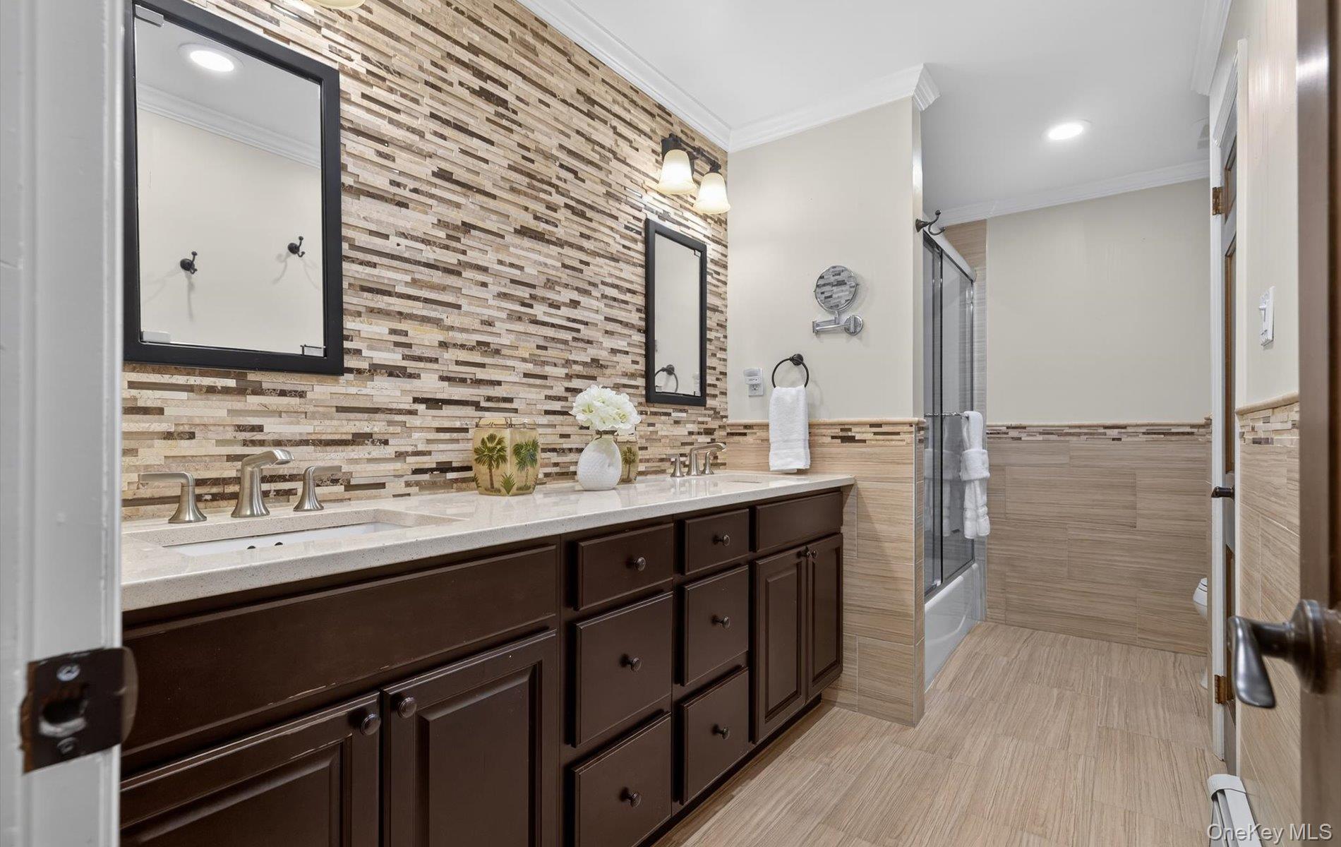 15 Tiber Road Syosset, NY 11791 - Photo 26 of 46 a bathroom with a sink a mirror and a shower