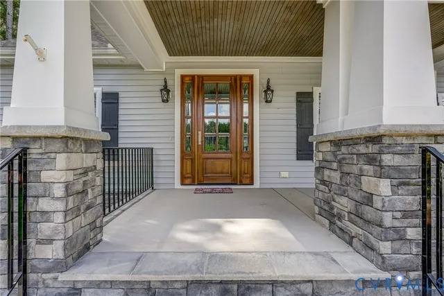 a view of front door of house with stairs