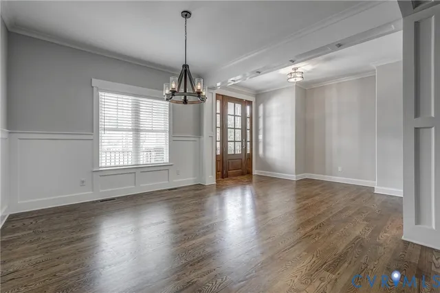wooden floor in an empty room with a window