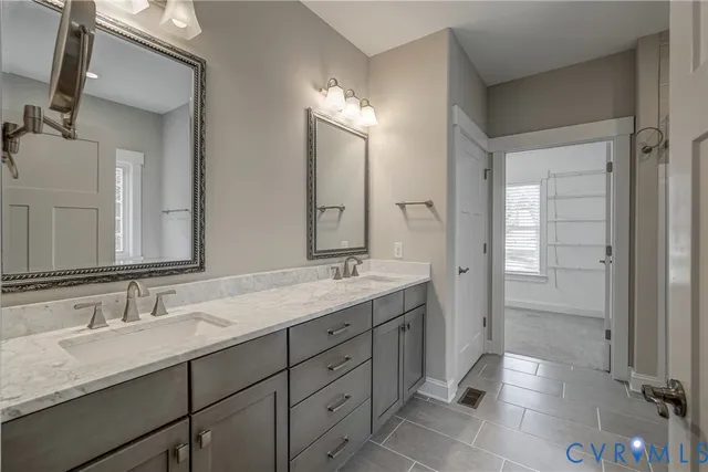 a bathroom with double sink and a mirror