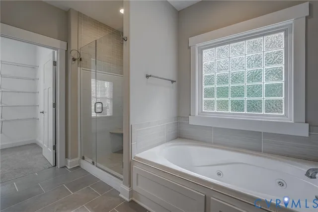 a bathroom with a bathtub and shower