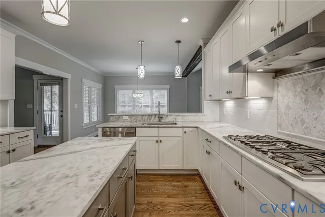 a kitchen with a stove sink and cabinets