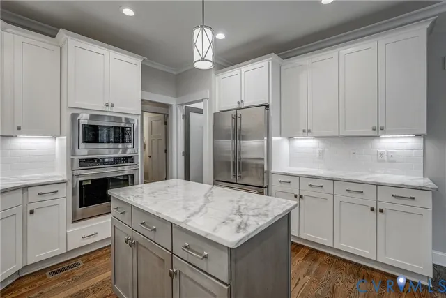 a kitchen with a sink stainless steel appliances and cabinets