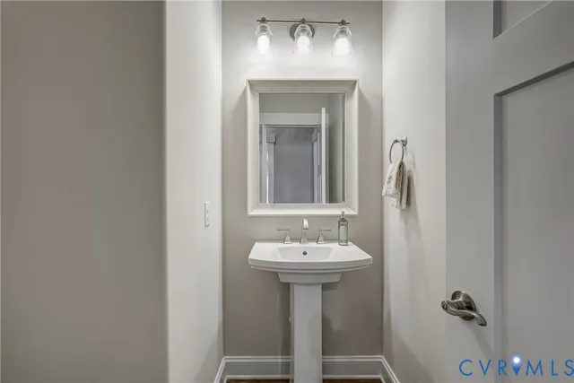 a bathroom with a sink mirror and toilet