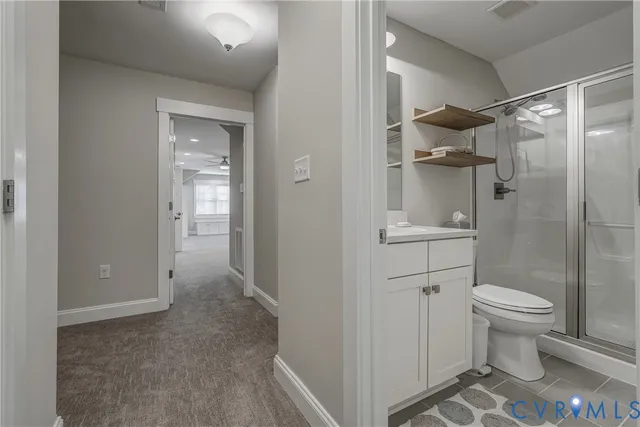 an empty room with windows and ceiling fan