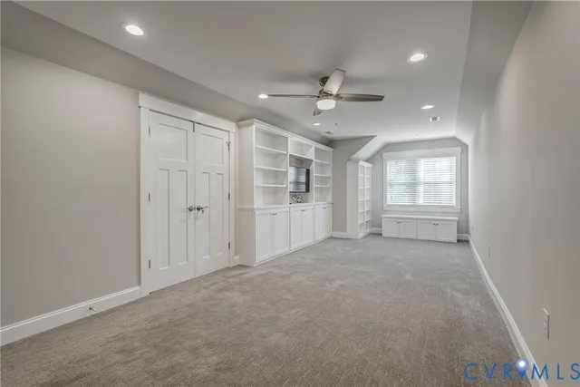 an empty room with windows and closet