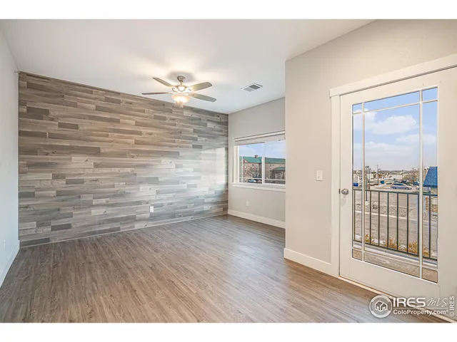 a view of an empty room and wooden floor