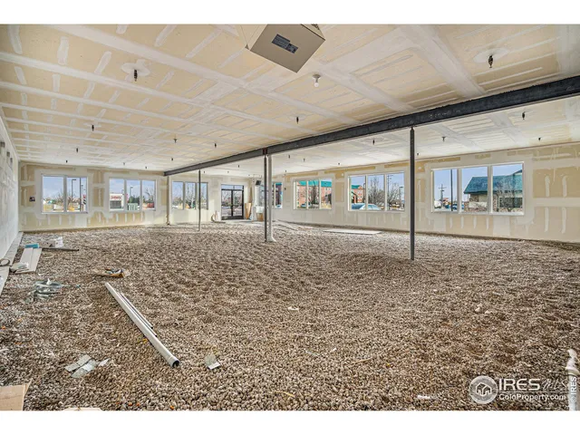 a big room with wooden floor and windows