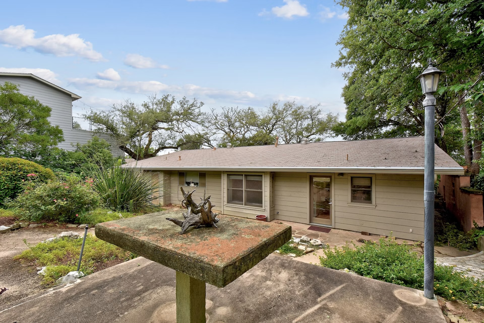 2117 A Rabb Road Austin, TX 78704 - Photo 19 of 21 Mature trees frame a charming single-story exterior.