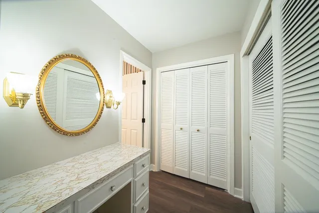 a bathroom with a granite countertop sink and a mirror