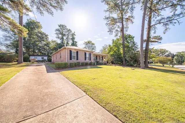 a swimming pool with trees in front of it