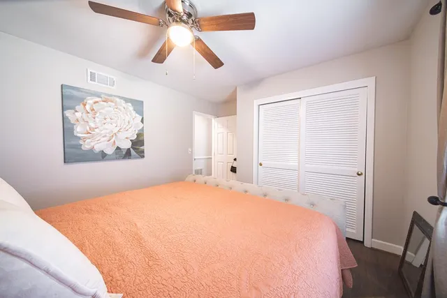 a bedroom with a large bed and a chandelier