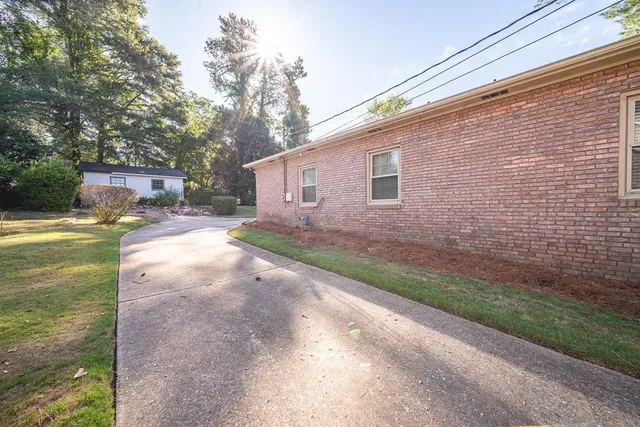 a backyard of a house with yard and outdoor seating