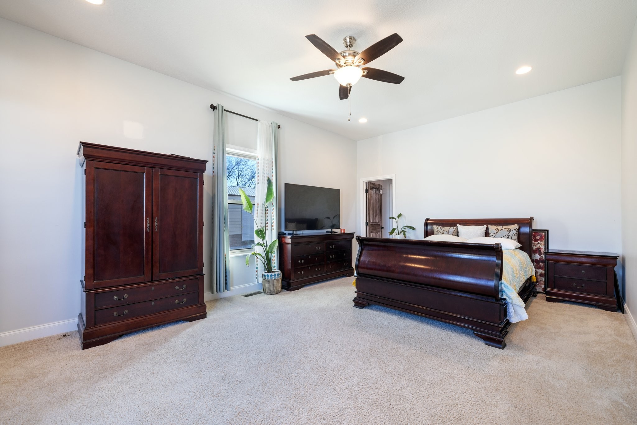 4785 Pulliam-Hardaway Road Springfield, TN 37172 - Photo 19 of 67 a spacious bedroom with a bed and a chandelier