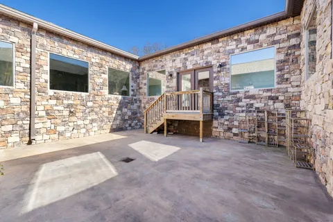 a view of a house with a backyard and a patio