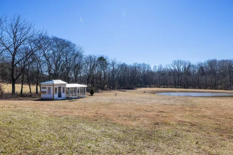 a backyard of a house with table and chairs