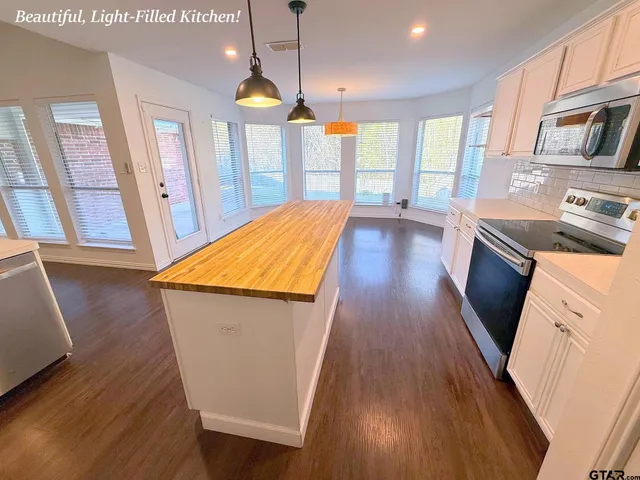 a view of a kitchen with wooden floor and staircase