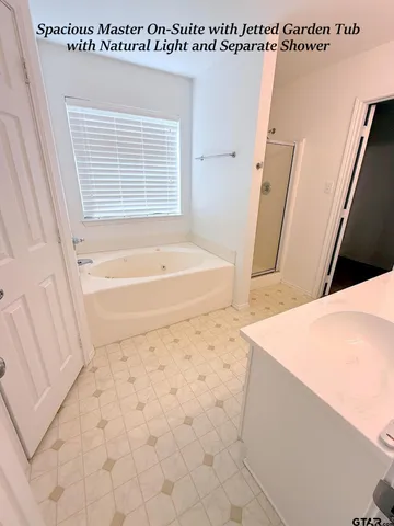 a bathroom with a bathtub sink and a shower