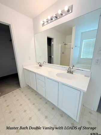 a spacious bathroom with a sink a mirror and vanity