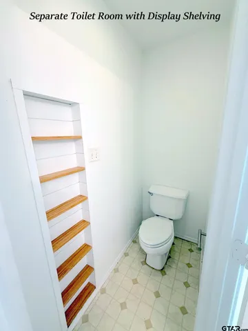 a bathroom with a toilet and a sink