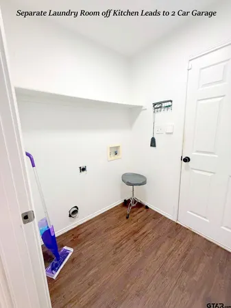 a view of a hallway with wooden floor and closet