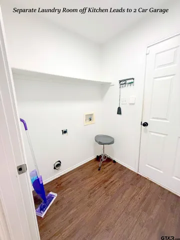 a view of a hallway with wooden floor and closet