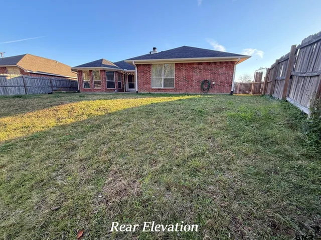 a view of a house with a yard and a porch