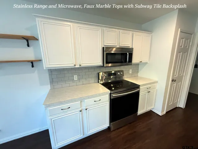 a kitchen with a sink stove and microwave