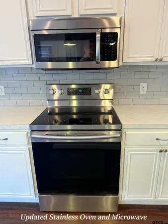 a stove top oven sitting inside of a kitchen