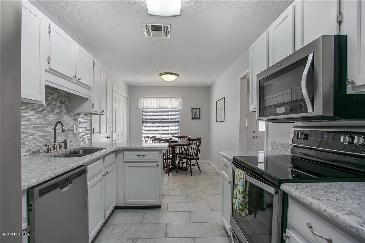 1606 Rusty Rail Road Jacksonville, FL 32225 - Photo 8 of 19 a kitchen with a sink stove and cabinets