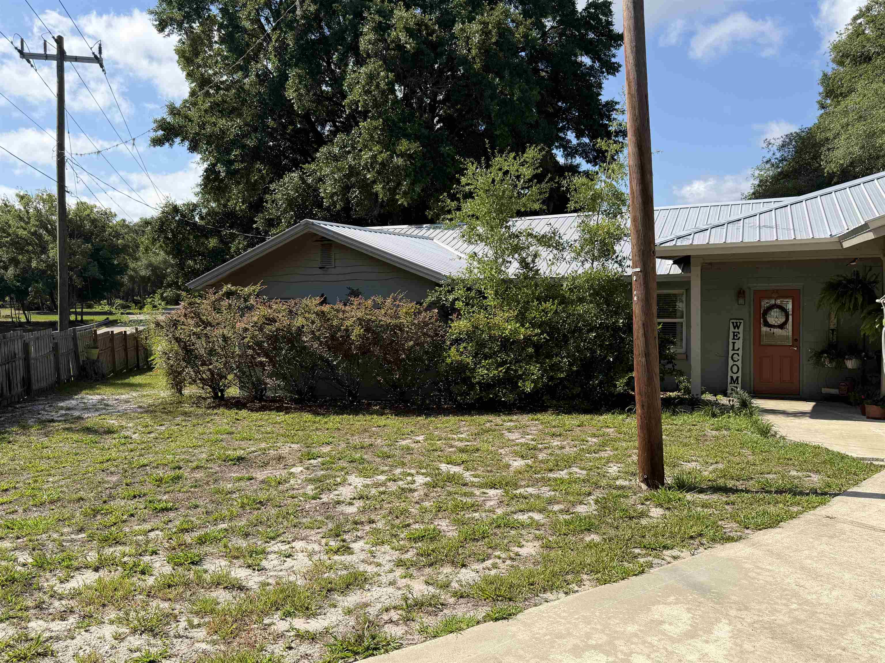 323 Sisco Road Pomona Park, FL 32181 - Photo 3 of 31 a backyard of a house with lots of green space