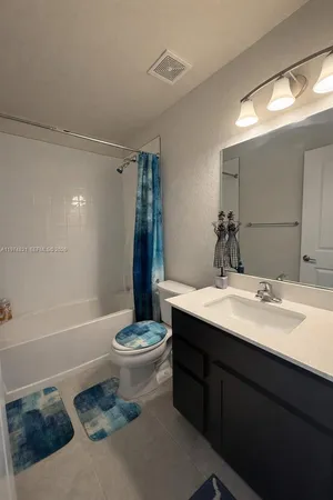 a bathroom with a sink a toilet and a bathtub