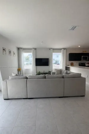 a room with furniture and flat screen tv