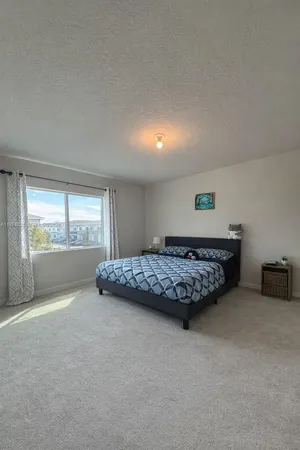 a room with a bed and window