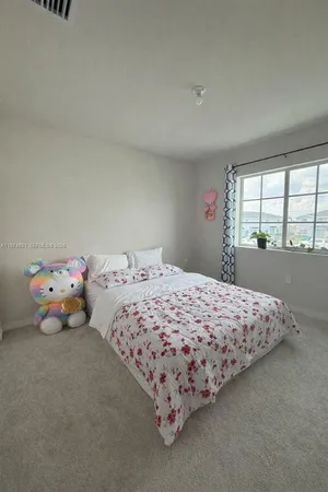 a bedroom with a bed and window