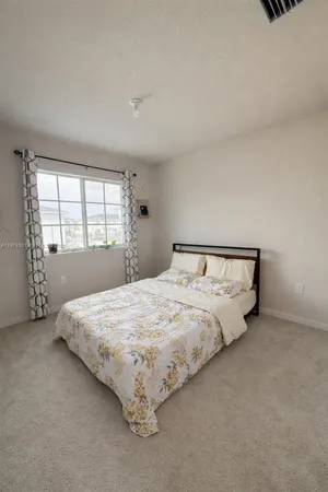a bedroom with a bed and window
