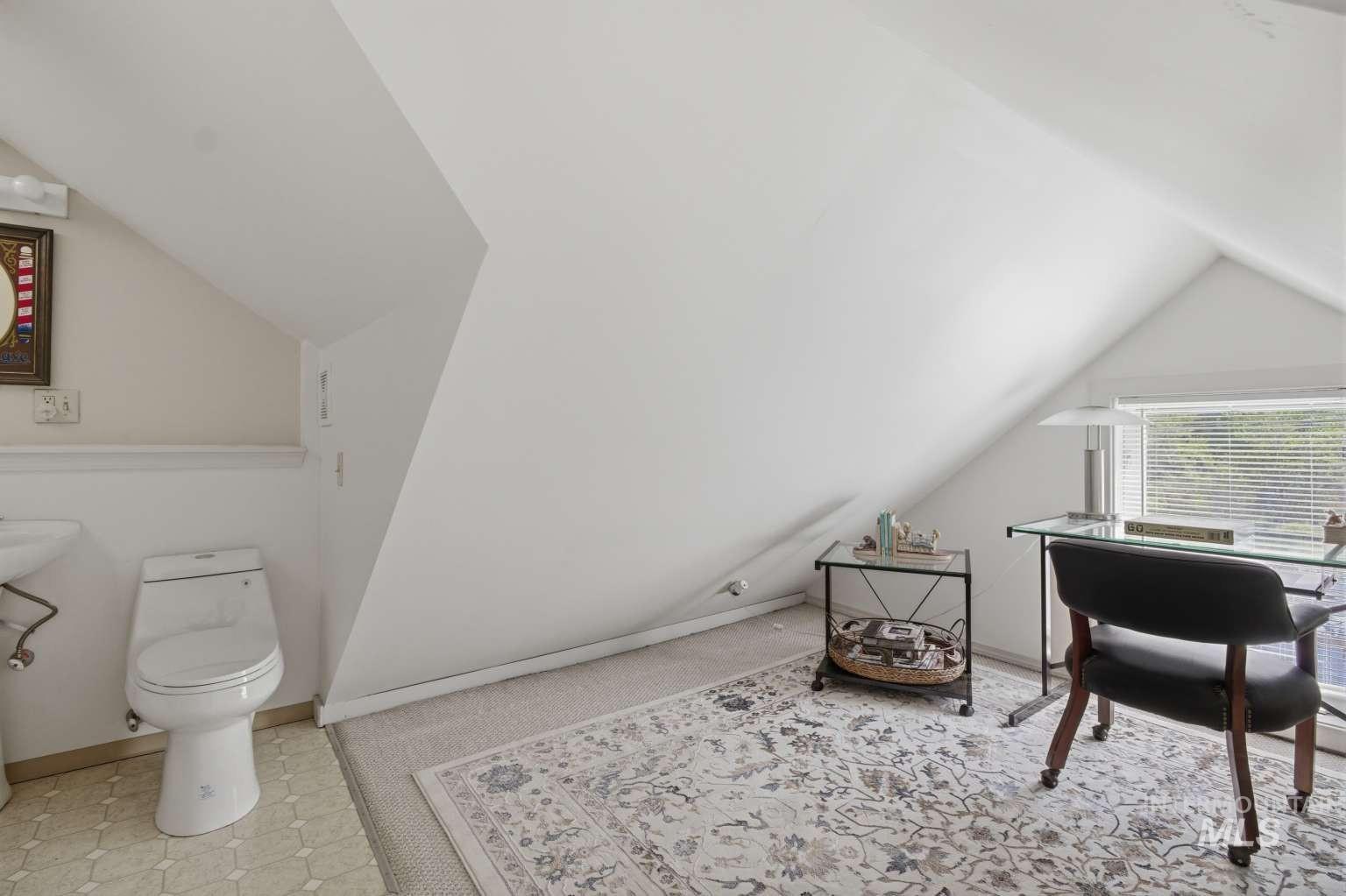 901 Main Street Kendrick, ID 83537 - Photo 34 of 50 Attic room featuring sloped ceilings, a window with blinds, and light-toned carpeting