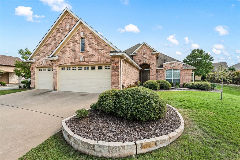 10605 Murray S Johnson Street Denton, TX 76207 - Photo 2 of 38 View of front of home featuring brick siding, concrete driveway, a front lawn, and an attached garage