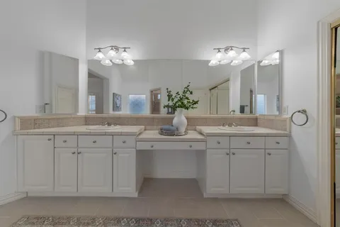 a bathroom with a double vanity sink and a mirror