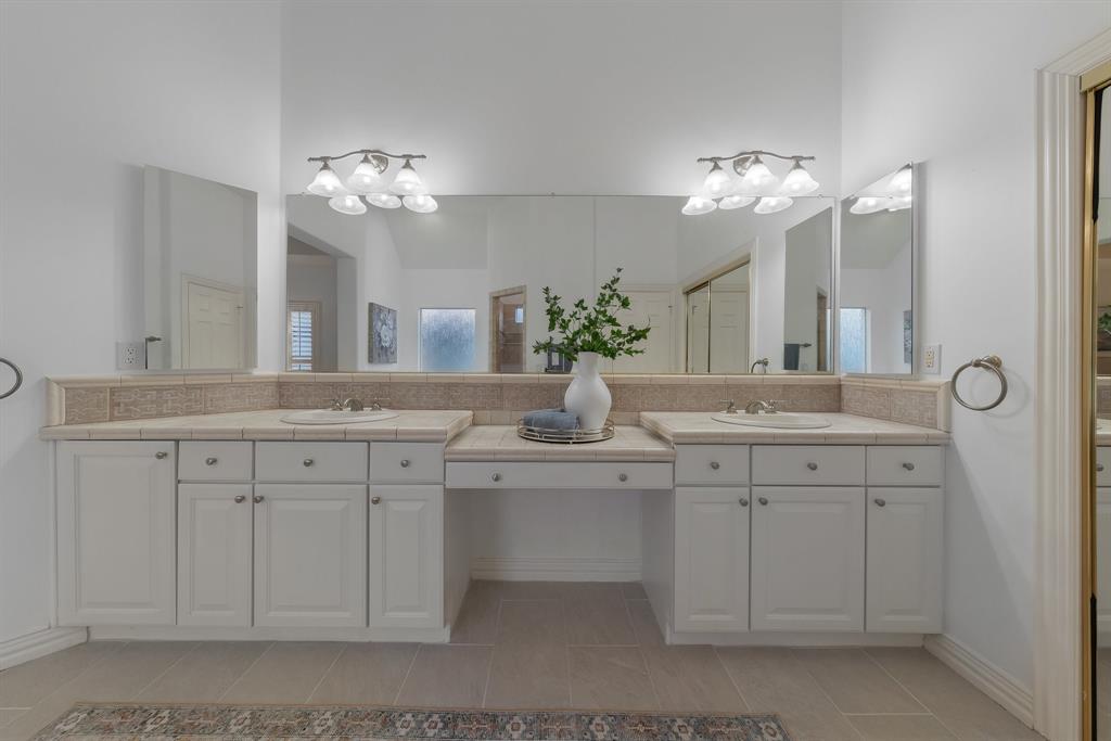 10605 Murray S Johnson Street Denton, TX 76207 - Photo 27 of 40 a bathroom with a double vanity sink and a mirror
