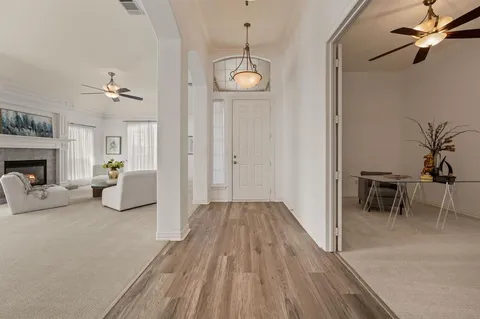 a living room with furniture a fireplace and a table