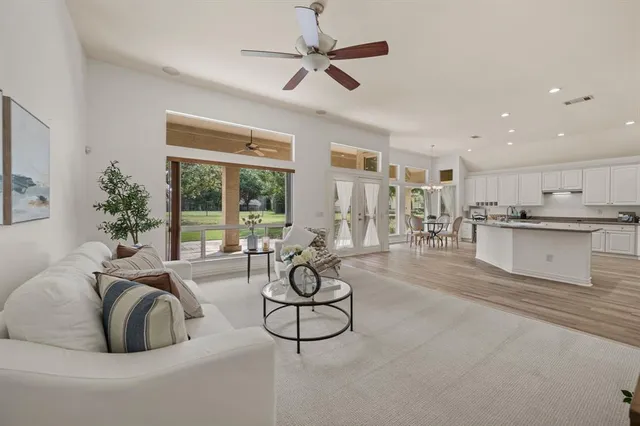 a living room with furniture a fireplace and a table