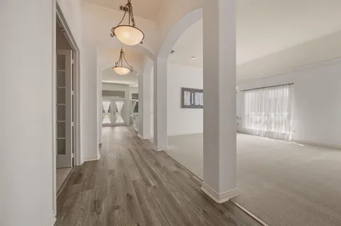 a view of hallway with wooden floor