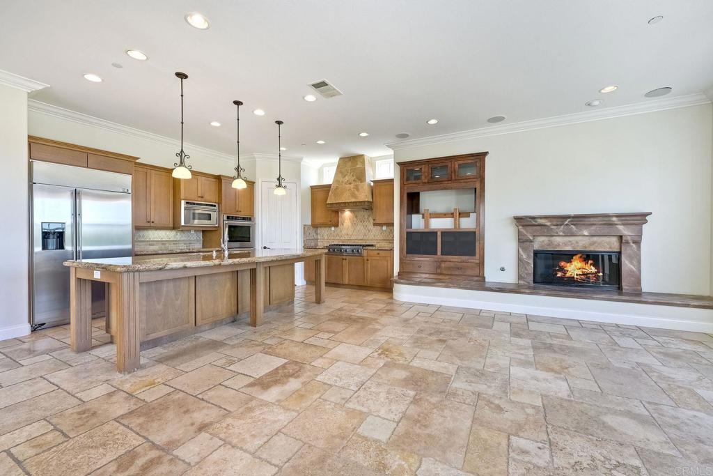 2606 Canto Rompeolas San Clemente, CA 92673 - Photo 5 of 18 a large white kitchen with cabinets and flat screen tv