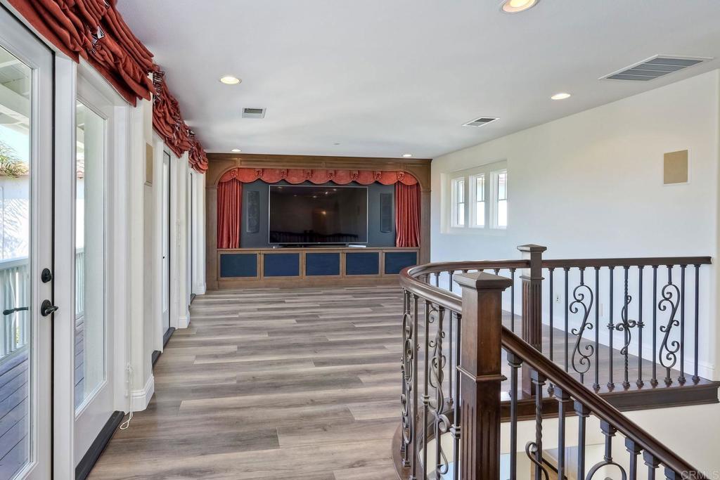 2606 Canto Rompeolas San Clemente, CA 92673 - Photo 7 of 18 a view of a hallway with wooden floor and windows