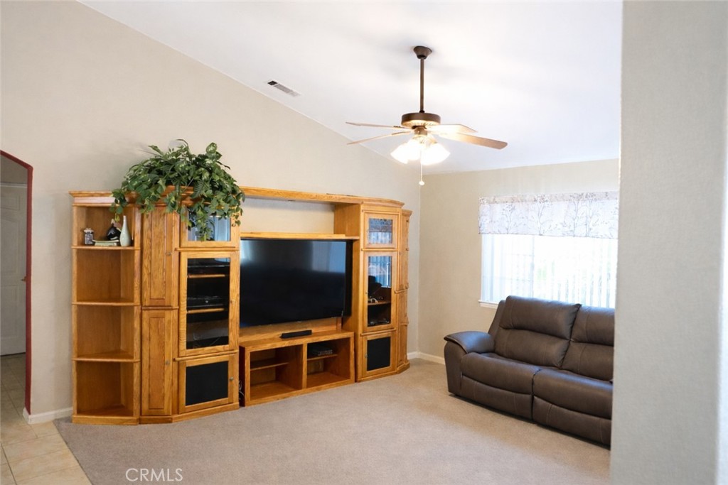 19095 Glenwood Avenue Riverside, CA 92508 - Photo 3 of 14 a living room with furniture and a flat screen tv